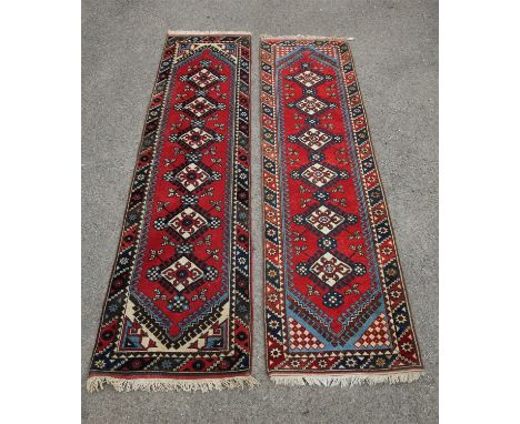 Turkish runner, the six serrated medallions on a red field within a blue and red border, 278 x 74 cm and another similar runn