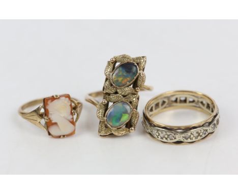 A band ring set with paste stones in 9 ct yellow and white gold, size O, a shell cameo ring, size K, and a composite opal pan