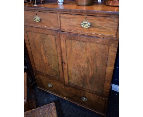 A 19th century mahogany bedroom press cabinet, slightly oversailing rectangular top above two short drawers, a pair of panel 