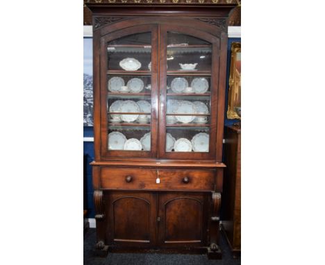 A Victorian mahogany secretaire library bookcase, concave moulded cornice above a pair of glazed doors enclosing four shelves