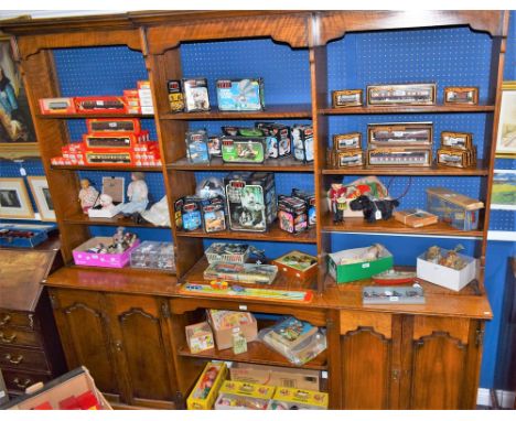 A substantial library bookcase, outswept cornice above a break-centre upper stage with an arrangement of open shelves, the pr