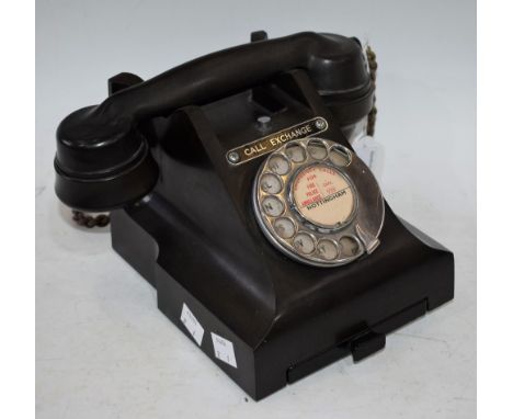 A mid 20th century black Bakelite telephone, call exchange button, label, with number slide to base, marked 312L S56/3A