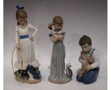 A Lladro figure, Girl with Kittens; others Nao, Girl with Puppy and Hoop; Boy with Puppy, printed marks (3)