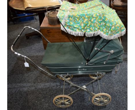 A vintage 1960's Silver Cross dolls pram, folding dark green body, chromed metal highlights, folding chrome chassis, white ru