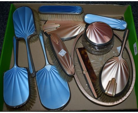 An Art Deco silver engine turned enamel dressing table brush set, in salmon pink, comprising oval cut glass tray, powder bowl