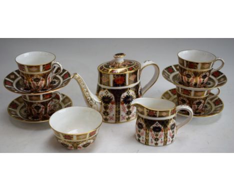 A Royal Crown Derby 1128 pattern tea set for four, comprising teapot, milk jug, sugar bowl, cups and saucers, printed and pai