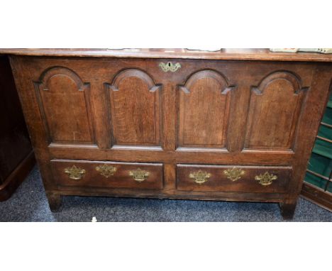 A George III oak mule chest, hinged rectangular top above a four panel front and two short drawers, 147.5cm wide