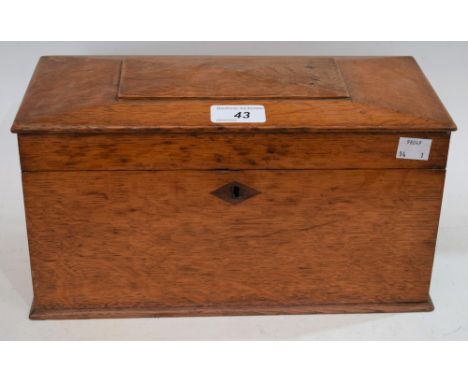 An oak rectangular tea caddy, the hinged top enclosing three compartments, 31cm wide