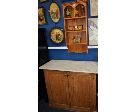 A pine farmhouse cupboard, marble top; a pine wall shelf (2)