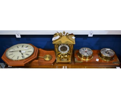 A mid 20th century brass anniversary clock; a 20th century mounted brass clock and barometer; a quartz wall clock (3)