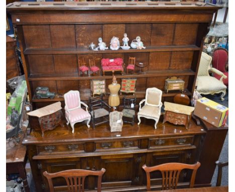 A substantial George III style oak dresser, concave cornice above three plate racks, the projecting base with three short dra