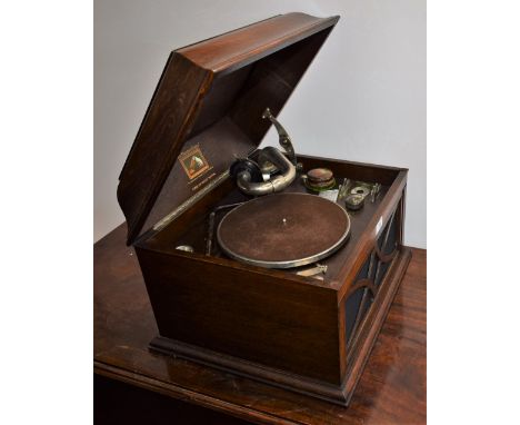 A vintage HMV table top gramophone, oak case, speaker grill; a collection of 78's