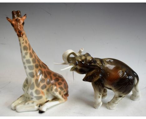 A Royal Dux study, of an elephant with raised trunk; a Russian USSR model, of a seated giraffe (2)