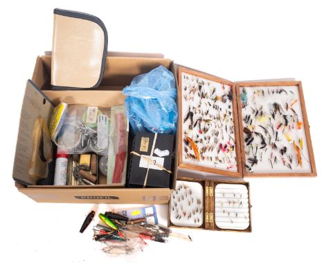 A collection of fly fishing equipment comprising  several boxes of steel eye flies,  weights,  spinning lures and accessories