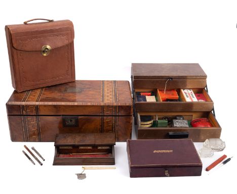 A late 19th century inlaid walnut writing slope, together with two leather stationary cases, an oak pens stand and a collecti
