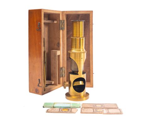 A 19th century lacquered brass filed microscope, with sling tube focus, together with four slides in a wooden case.