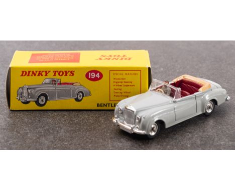 Corgi No. 194 Bentley Copue, grey with maroon interior and driver figure, silver trim and spun hubs, in a yellow box.