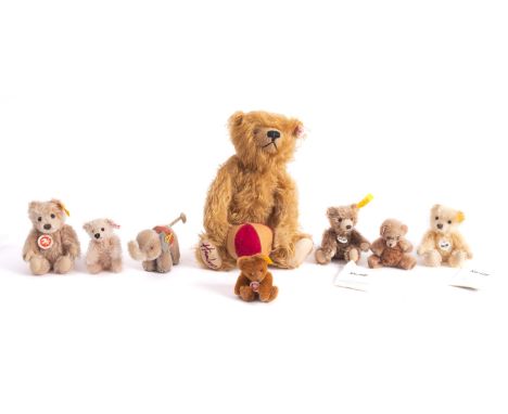 A group of Steiff bears, including a Hamley's blonde bear holding a stripped ball 24cm high, with a miniature elephant, and  