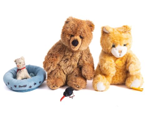 Two Steiff bears, 'Molly' cat 33cm high, a brown bear, together with a Steiff pet bed, a miniature kitten with red bow and sm