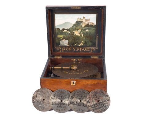 A late 19th century walnut cased table Polyphon, with lithograph landscape to underside of lid,  together with one  9.5inch d