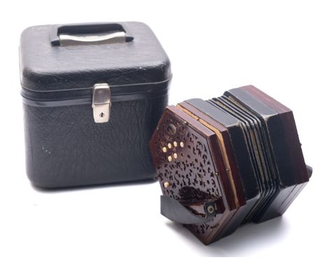 An early 20th century ebony twenty-one key concertina by Lachnel & Co, serial number 190492, with hexagonal fret cut end and 