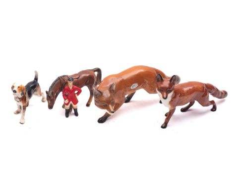 A Beswick model of a fox together with a Sylvac model of a fox , a continental figure of a huntsman and another of a hound.