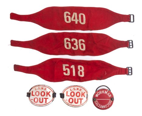 Two LSWR enamel 'Look Out' arm bands, and enamel 'Workman Disconnected' enamel badge and three red cloth numerical arm bands.