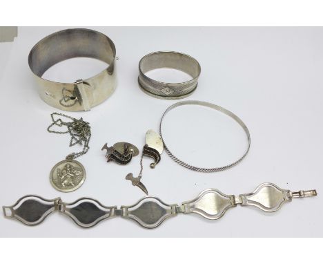 Silver and white metal items; bracelet, two bangles, a napkin ring, cufflinks and a St. Christopher and chain, 92g 