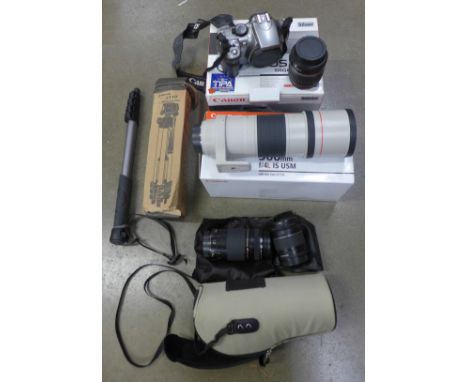 A collection of cameras including Canon, four lenses (including Canon EF300mm f/4L IS USM) and a tripod