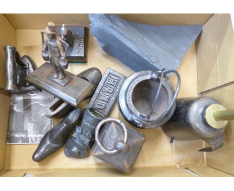 A collection of cast iron items including a Well's engineer lamp, shoe, weight, etc. 