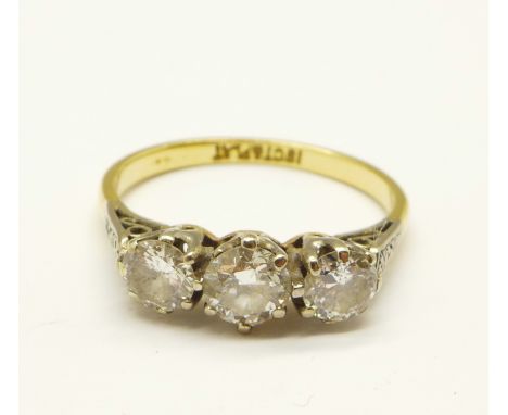 An 18ct gold and platinum set three stone diamond ring, centre stone approximately 0.5carat diamond weight, 2.8g, O 