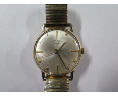 A 9ct yellow gold Rotary manual wind gents wristwatch with a 34mm case on a sprung strap, running, some spotting to dial - to