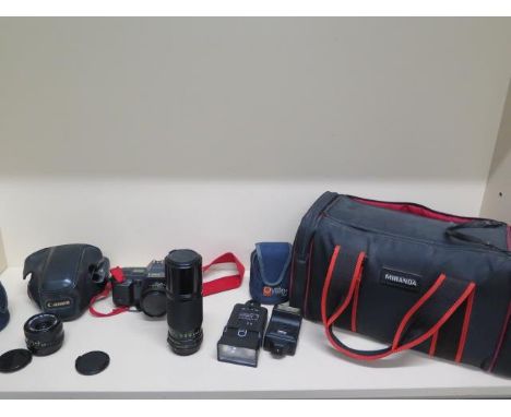 A Canon T70 35mm SLR camera, Canon 50mm lens, Canon 28mm lens and Canon 100-200mm lens with two flashes and bag , camera work