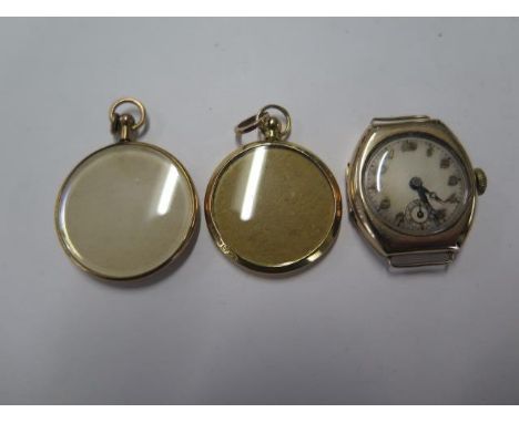 A 9ct yellow gold manual wind watch head - 23mm case - running and two 9ct yellow gold locket pendants - total approx weight 