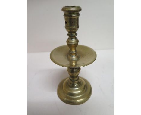 An 18th century brass candlestick with drip tray - Height 20cm 