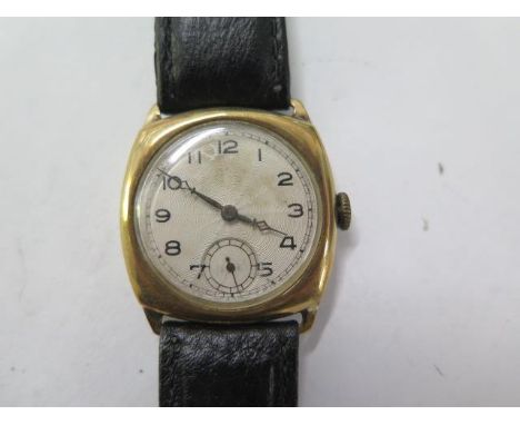 A 9ct yellow gold gents manual wind gents wristwatch with 29mm case on a leather strap - running, hands adjust - total weight