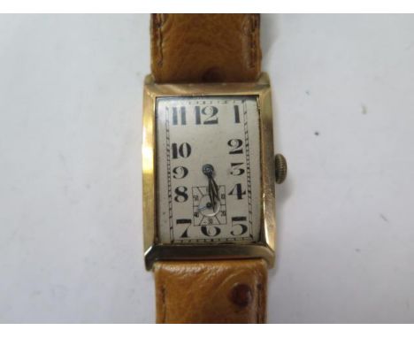 A 9ct yellow gold gents manual wind wristwatch on a leather strap - 23mm case - running, hands adjust - total weight approx 2