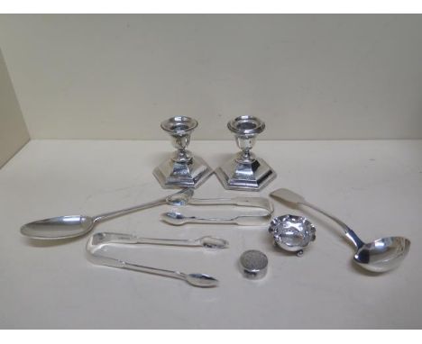 Two silver sugar nips, a silver ladle, a silver spoon, a silver salt, small silver pot and a  pair of small weighted silver c