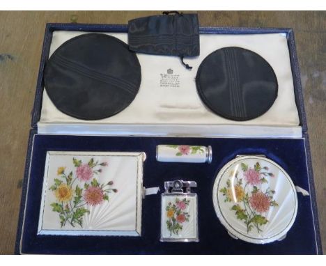 A Garrard &amp; Co Ltd silver ladies floral decorated travel set with cigarette case, compact and lipstick holder, also a sil