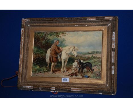 A framed Picture of a horse and two dogs with their master after a days hunting.