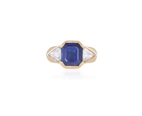 A SAPPHIRE AND DIAMOND RINGThe rectangular step-cut sapphire within collet setting, weighing approximately 4.00cts, between t