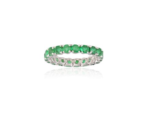 AN EMERALD ETERNITY RING, BY CARTIER The continuous row of circular-cut emeralds, each within four-claw setting, with maker's