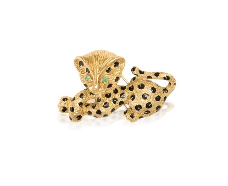 A NOVELTY BROOCH, BY FREDThe whimsical leopard, textured gold to represent fur, with black enamel spots to the body and emera