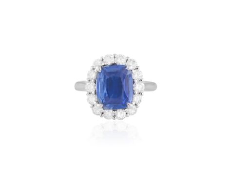 A SAPPHIRE AND DIAMOND CLUSTER RINGThe cushion-shaped sapphire weighing 4.01cts, within a round brilliant-cut diamond surroun