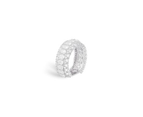 A DIAMOND DRESS RINGSet to the front with a central row of oval-shaped diamonds between frames of similarly-cut diamonds, mou