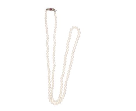 A CULTURED PEARL NECKLACE WITH RUBY AND DIAMOND CLASPComposed of a long row of graduated cultured pearls of cream tint, measu