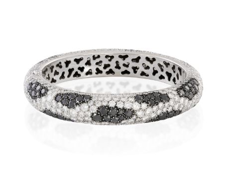 A DIAMOND AND BLACK DIAMOND BANGLE, BY DE GRISOGNO &amp; CHOPARDThe hinged bangle patinated with sections of circular-cut bla
