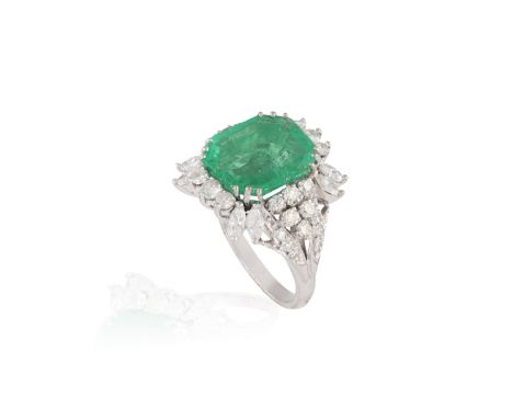 AN EMERALD AND DIAMOND DRESS RINGThe octagonal-shaped emerald weighing approximately 5.00cts, within a triple four-claw setti