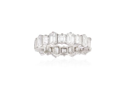 A DIAMOND ETERNITY RINGDesigned as a continuous row of alternating square and step-cut diamonds, mounted in gold, diamonds ap