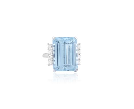 AN AQUAMARINE AND DIAMOND COCKTAIL RINGThe rectangular-cut aquamarine weighing approximately 14cts, between round brilliant-c